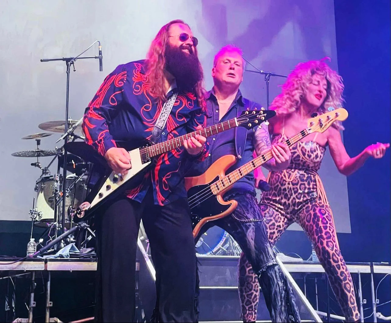 Guitarist and bass player performing alongside Julie Nevada